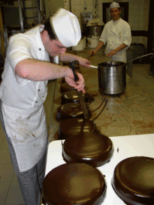 Alfred Buxbaum at work frosting Sacher tortes