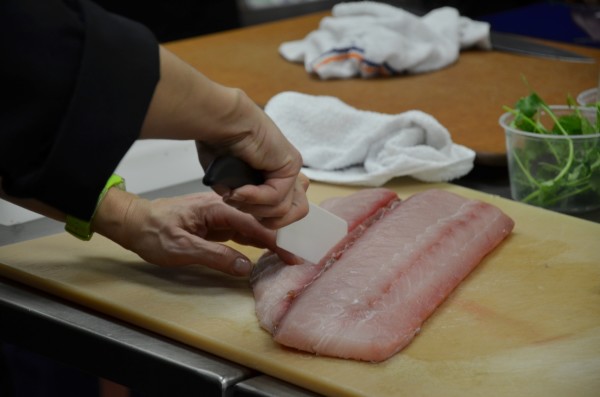 Slicing fish in the cooking class.