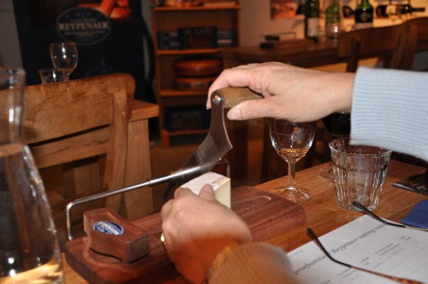 Cutting different cheese samples.