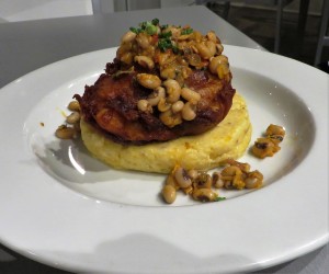 Fried Gulf Fish over stone ground grits topped with black-eyed pea salad.