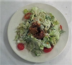 Salad Maison with romaine lettuce, grape tomatoes, crumbled bleu cheese and pecans