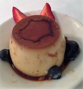 Caramel Cup Custard garnished with blueberries and strawberries