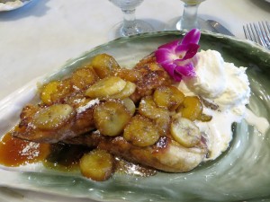 Bananas Foster Pain Perdu, garnished with an orchid.