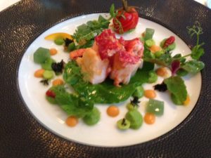 Lobster vinaigrette, pea purée, ginger, mint and orange peel, sweet and sour tomatoes, and wild herbs