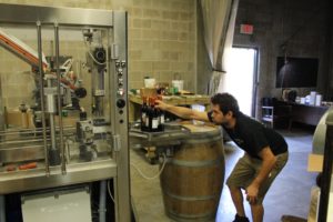 Chris overseas the bottling process for Quantum Leap Winery/